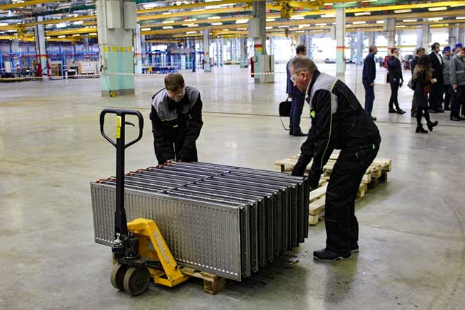 работники складывают радиаторы отопления